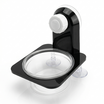 Mangeoire reptile ventouse simple noir mat, bras courbe ventouse 
blanche ronde proéminente, bol circulaire transparent peu profond 
fixé platine noire, deux petites ventouses transparentes coins bas, 
design minimal noir et transparent, fond blanc studio éclairage 
professionnel, format JPG 1:1